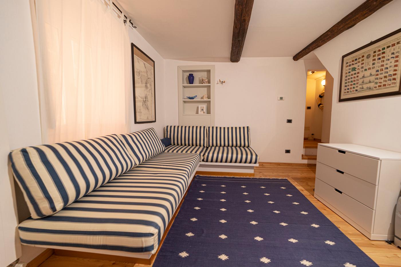 Lower lounge with striped sofas at La Nave