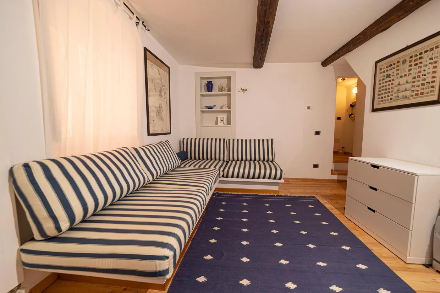 Lower lounge with striped sofas at La Nave