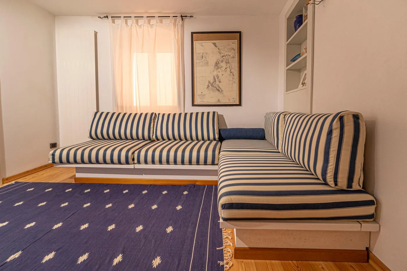 Second view of the lounge with striped sofas